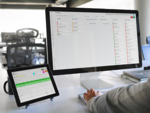 Office workspace showing workforce management software dashboards display