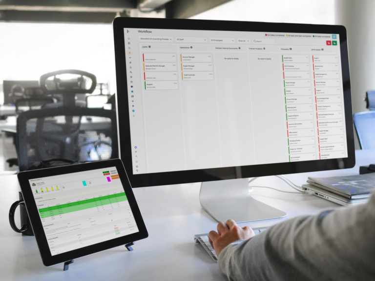 Office workspace showing workforce management software dashboards display